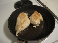 Pan with chicken breast frying
